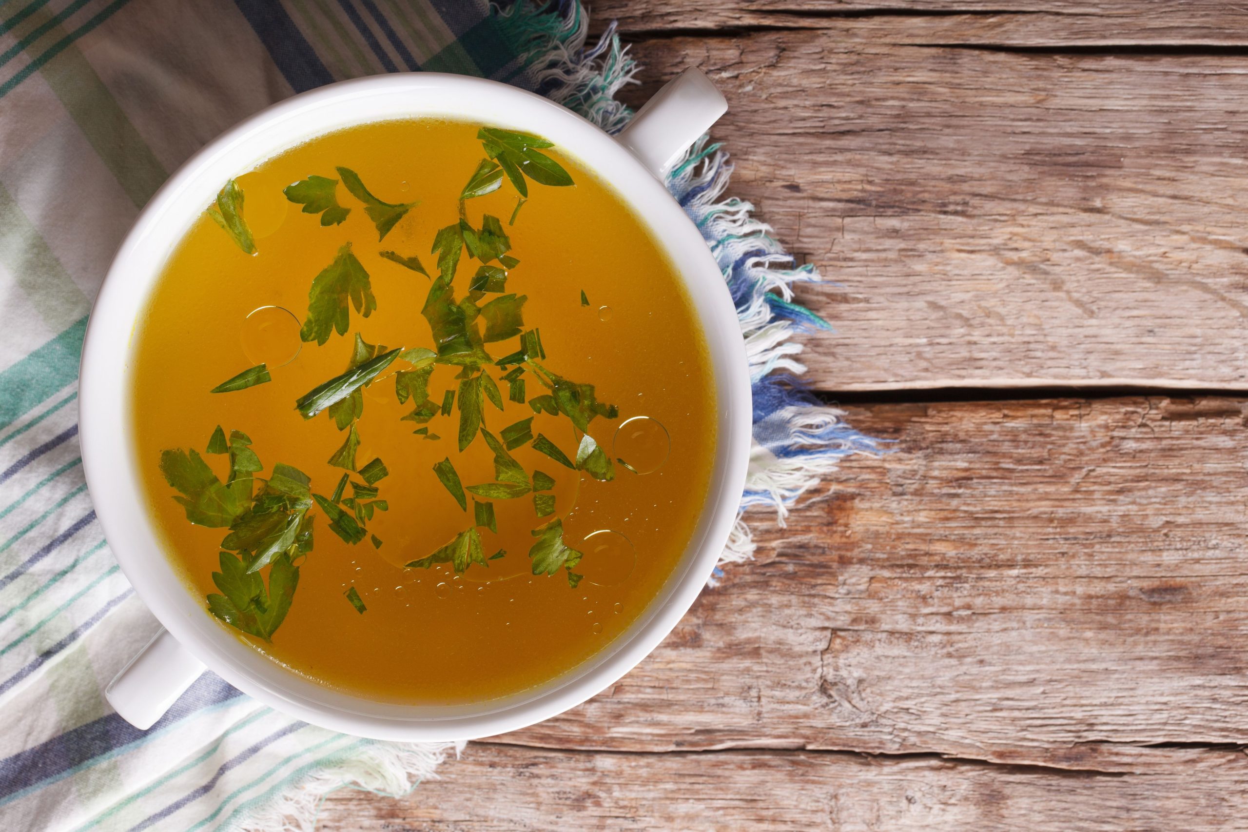 meat-broth-with-parsley-in-bowl-closeup-horizontal-royalty-free-image-494023846-1538777081-scaled.jpg